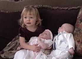 Big sister with twins at two months.